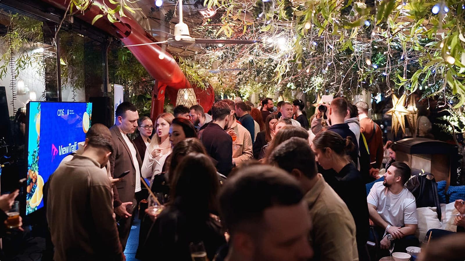 Guests talking at an ANS evening under a garden canopy